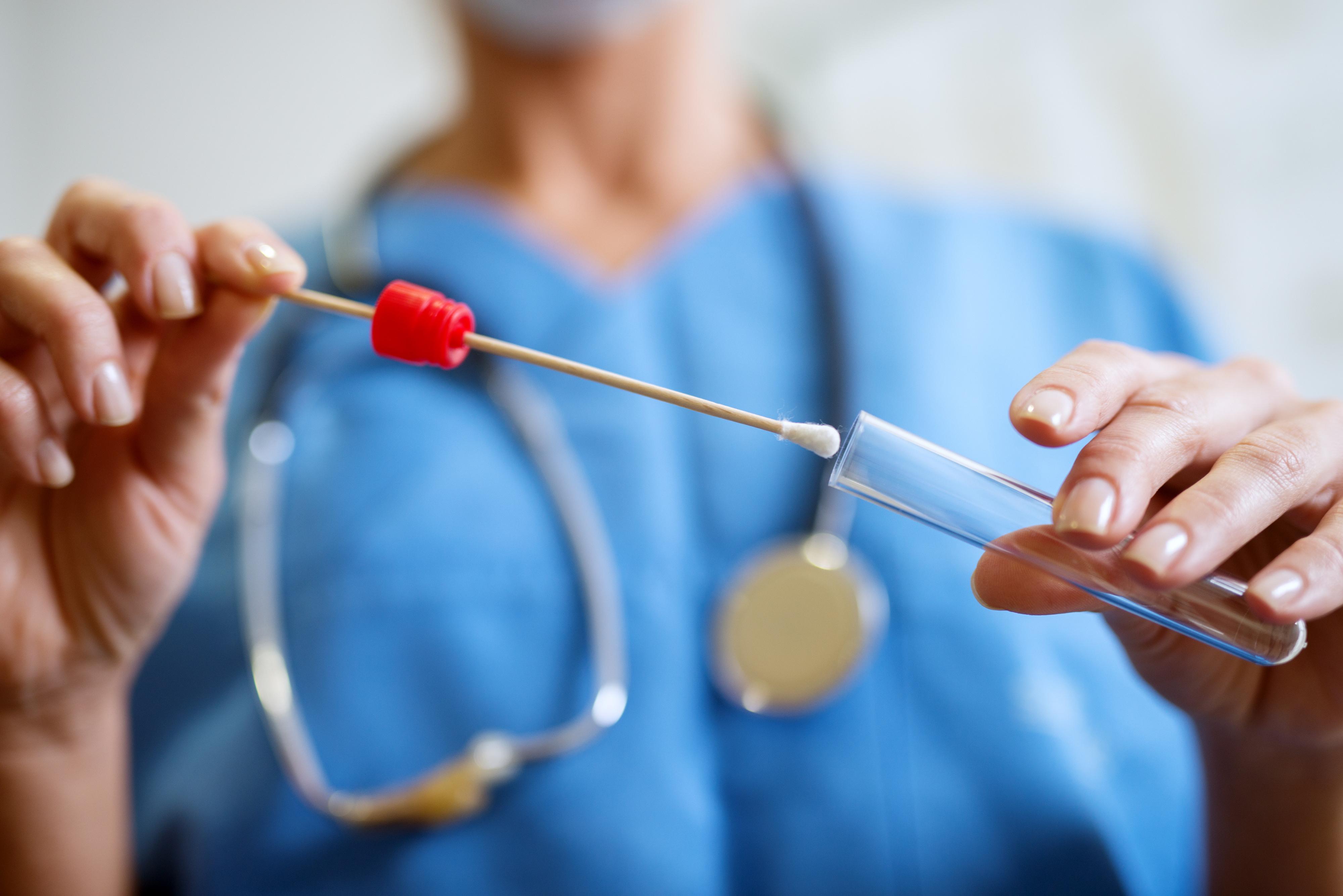 a forensic nurse puts a testing swab away