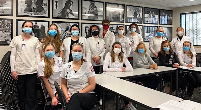 a group of nursing students pose in a covid vaccine clinic