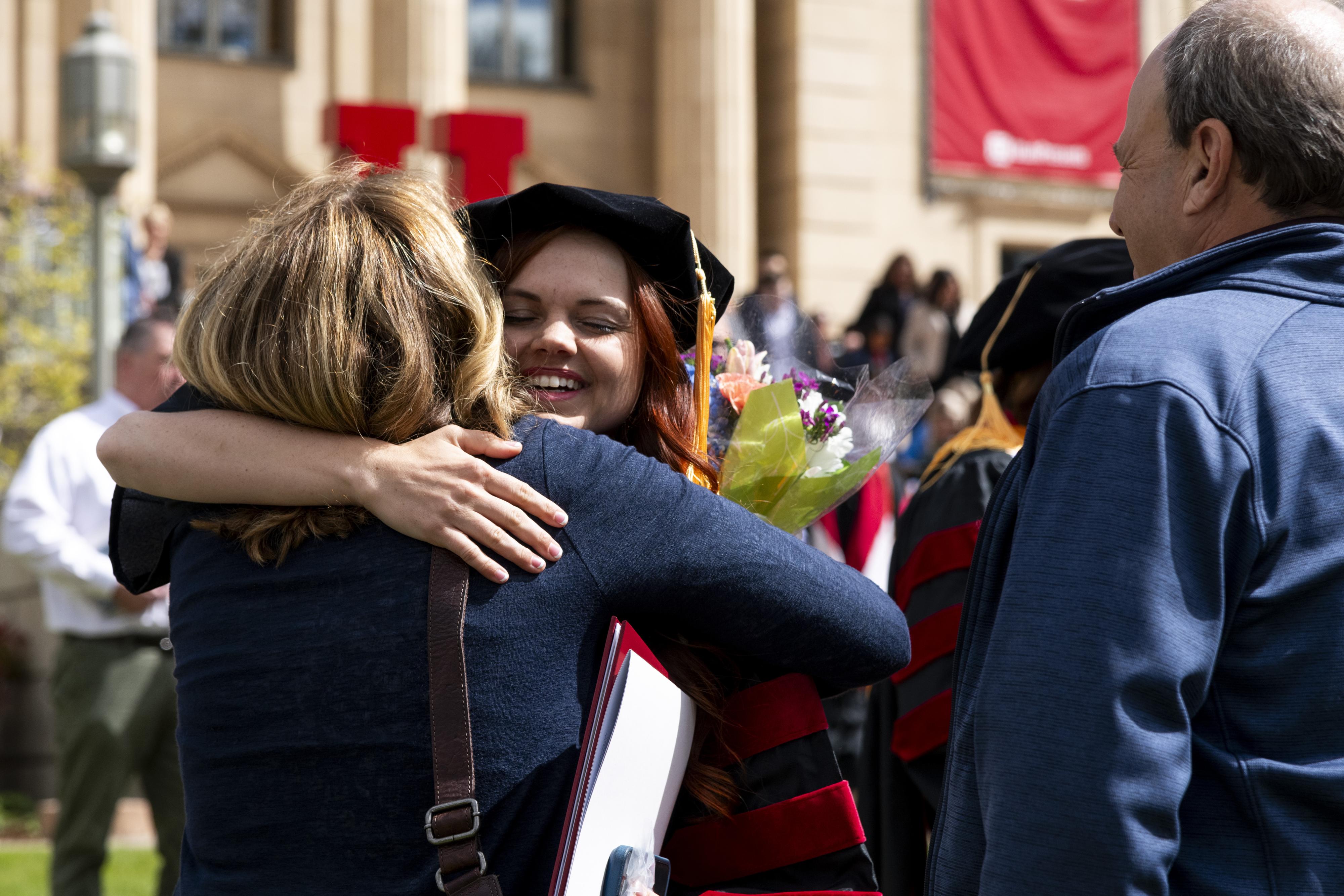 A graduate embraces a supporter
