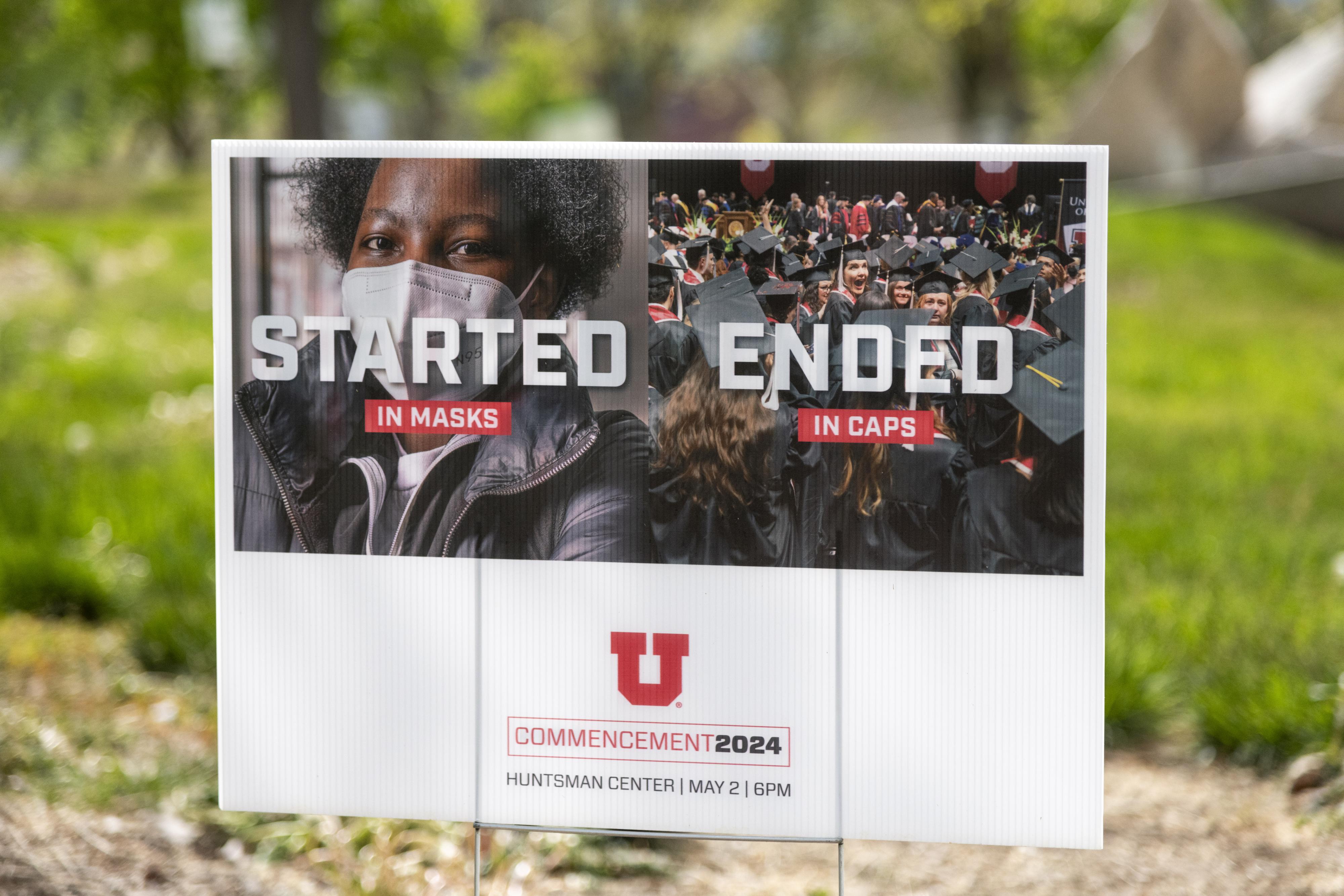 A yard sign stating "started in masks, ended in caps"